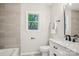 Modern bathroom with marble vanity, black fixtures, a window, and stylish decor at 6813 Elm Forest Dr, Charlotte, NC 28212