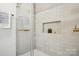 Updated bathroom with beige tile and a glass enclosed shower with a built-in niche at 6813 Elm Forest Dr, Charlotte, NC 28212
