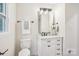 Bright bathroom featuring a white vanity with marble countertop and modern fixtures at 6813 Elm Forest Dr, Charlotte, NC 28212