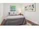 Well-lit bedroom with wood floors, a window, and stylish decor at 6813 Elm Forest Dr, Charlotte, NC 28212
