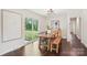 Cozy dining room with a wooden table, bench seating, sliding glass door leading to the backyard, and stylish decor at 6813 Elm Forest Dr, Charlotte, NC 28212