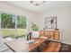 Bright dining room with a rustic wooden table, artful decor, and a sliding glass door offering backyard views at 6813 Elm Forest Dr, Charlotte, NC 28212