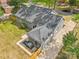 Aerial view of a gray brick home with a dark roof, a fenced-in yard, and a paved driveway for easy parking at 6813 Elm Forest Dr, Charlotte, NC 28212