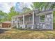 Charming gray brick home with a cozy porch, fresh landscaping, and a newly installed porch railing at 6813 Elm Forest Dr, Charlotte, NC 28212