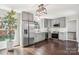 Modern kitchen featuring stainless steel appliances, gray cabinets, and dark hardwood flooring at 6813 Elm Forest Dr, Charlotte, NC 28212