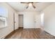 Bright bedroom features wood-look flooring, neutral paint, ceiling fan, and closet at 735 Green St, Rock Hill, SC 29730