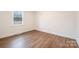 Bedroom features wood-look flooring, neutral paint, and window at 735 Green St, Rock Hill, SC 29730