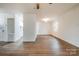 Spacious living room with hardwood flooring, white walls, and access to the kitchen area at 735 Green St, Rock Hill, SC 29730