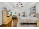 Spacious bedroom with a hardwood floors, a ceiling fan, and a large window at 7362 Vanguard Ct, Stanley, NC 28164