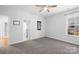 This is a light and bright bedroom with neutral carpeting, a ceiling fan, and natural light from the window at 7362 Vanguard Ct, Stanley, NC 28164