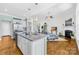 Spacious kitchen island with granite countertops overlooks a cozy living room with fireplace and open floor plan at 7362 Vanguard Ct, Stanley, NC 28164