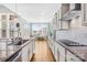 Well-equipped kitchen boasting granite countertops, stainless steel appliances, and plenty of natural light at 7362 Vanguard Ct, Stanley, NC 28164