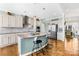 Modern kitchen with a central island, stainless steel appliances, and an open design at 7362 Vanguard Ct, Stanley, NC 28164