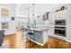 Bright kitchen featuring stainless steel appliances, granite countertops, and a center island with barstool seating at 7362 Vanguard Ct, Stanley, NC 28164