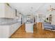 Bright living room with a view of the kitchen island and a fireplace, creating a cozy and inviting atmosphere at 7362 Vanguard Ct, Stanley, NC 28164