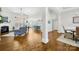 Open-concept living room with fireplace, hardwood floors, and abundant natural light at 7362 Vanguard Ct, Stanley, NC 28164