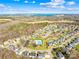 Aerial view of the neighborhood, showcasing the proximity to Lake Norman, community pool and surrounding trees at 7362 Vanguard Ct, Stanley, NC 28164