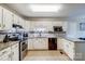 Clean kitchen with white cabinets and stainless steel appliances at 7921 Altacrest Dr, Concord, NC 28027