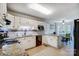 Bright eat-in kitchen with white cabinets, granite counters, and stainless steel appliances at 7921 Altacrest Dr, Concord, NC 28027
