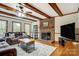 Comfortable living room with hardwood floors, brick fireplace and leather sofa at 7921 Altacrest Dr, Concord, NC 28027