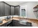 Modern butler's pantry featuring dark cabinetry, wood countertop, and stainless steel appliances at Lot 17 Ridgeview Ln, Iron Station, NC 28080