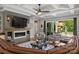 Cozy living room with fireplace, wood paneling, tray ceiling, and access to outdoor patio at Lot 17 Ridgeview Ln, Iron Station, NC 28080