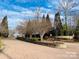 Beautiful brick road leading up to a neighborhood entrance with lush landscaping and mature trees at Lot 17 Ridgeview Ln, Iron Station, NC 28080