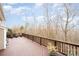 Large wooden back deck overlooking natural scenery and potted plants at 10349 Linksland Dr, Huntersville, NC 28078