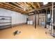 Unfinished basement with exposed beams, a washer, dryer, paint supplies, and a utility sink at 10349 Linksland Dr, Huntersville, NC 28078