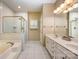 Bright bathroom with a double vanity, a soaking tub, and a glass enclosed shower at 10349 Linksland Dr, Huntersville, NC 28078