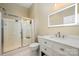Modern beige bathroom featuring a glass shower, LED mirror, white marble vanity, and updated fixtures at 10349 Linksland Dr, Huntersville, NC 28078