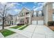 Charming townhome featuring a brick facade, balcony, two-car garage and manicured lawn at 10349 Linksland Dr, Huntersville, NC 28078