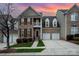 Elegant brick townhouse with a balcony and two-car garage at 10349 Linksland Dr, Huntersville, NC 28078