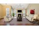Inviting living room with a fireplace, large windows, and comfortable seating at 10349 Linksland Dr, Huntersville, NC 28078