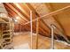 Spacious unfinished attic with wooden beams and flooring offers potential for extra storage or customization at 1133 Bloom Wood Ln, Matthews, NC 28105