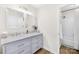 Bathroom features double sinks with white cabinets, mirrors, and natural light at 1133 Bloom Wood Ln, Matthews, NC 28105