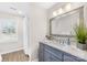 Modern bathroom vanity with a decorative mirror and a window at 1133 Bloom Wood Ln, Matthews, NC 28105