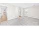 Bright bedroom with light-colored wood flooring and two white doors in a freshly painted interior at 1133 Bloom Wood Ln, Matthews, NC 28105