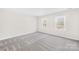 Bright bedroom with neutral walls, carpet, and two windows at 1133 Bloom Wood Ln, Matthews, NC 28105
