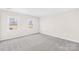 Bright bedroom with neutral walls, carpet, and two windows at 1133 Bloom Wood Ln, Matthews, NC 28105