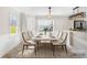 Staged kitchen and dining area, featuring tile flooring, beaded wainscotting, and a bright, airy atmosphere at 1133 Bloom Wood Ln, Matthews, NC 28105