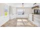 Bright eat-in kitchen with tile flooring, beaded wainscotting, granite countertops, and modern light fixtures at 1133 Bloom Wood Ln, Matthews, NC 28105