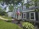 A well-maintained home with gray siding, black shutters, and a neatly landscaped front yard at 1133 Bloom Wood Ln, Matthews, NC 28105