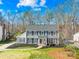 Charming two-story home with classic gray siding, black shutters, and a well-manicured front lawn at 1133 Bloom Wood Ln, Matthews, NC 28105