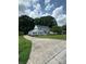 Gorgeous two-story home with gray siding, black shutters, a beautiful lawn, and mature trees at 1133 Bloom Wood Ln, Matthews, NC 28105