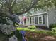Home featuring gray siding, black shutters, manicured landscaping, and an American flag on display at 1133 Bloom Wood Ln, Matthews, NC 28105
