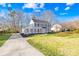 Charming two-story home featuring a well-manicured lawn, newly mulched beds, and classic architectural details at 1133 Bloom Wood Ln, Matthews, NC 28105