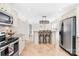 Kitchen features seating at the bar, stainless appliances, and an open floor plan at 1133 Bloom Wood Ln, Matthews, NC 28105