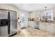 Bright kitchen featuring stainless steel appliances, tile flooring and backsplash, granite countertops and a backyard view at 1133 Bloom Wood Ln, Matthews, NC 28105