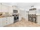 Modern kitchen featuring stainless steel appliances, tile flooring and backsplash, granite countertops and breakfast bar at 1133 Bloom Wood Ln, Matthews, NC 28105